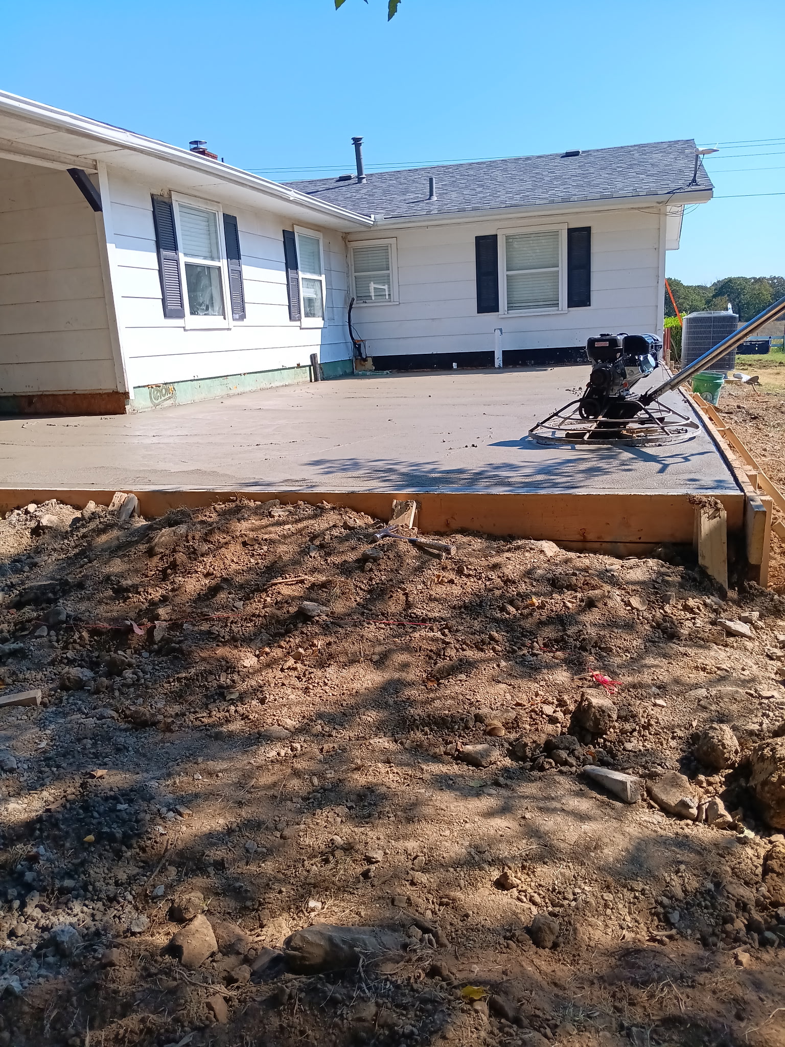 Finished concrete patio beside a single-story house